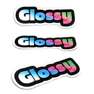 May include: Three glossy stickers with the word "Glossy" in a rainbow gradient font. The stickers are white with a black outline.