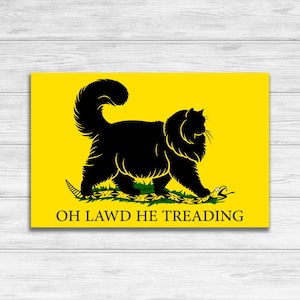 May include: A yellow flag with a black cat walking on a green snake. The text "OH LAWD HE TREADING" is printed below the cat.