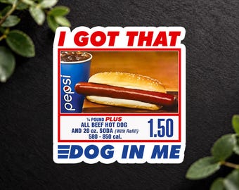 May include: A rectangular sticker featuring the text I GOT THAT DOG IN ME in blue and red. The center shows a hot dog in a bun and a blue Pepsi cup. Text includes 1/4 POUND PLUS ALL BEEF HOT DOG AND 20 oz. SODA (With Refill) 580 - 850 cal. 1.50.