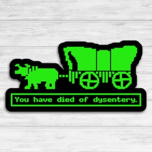 May include: A black and green sticker with a pixelated image of a covered wagon pulled by an ox. The text "You have died of dysentery." is below the image.