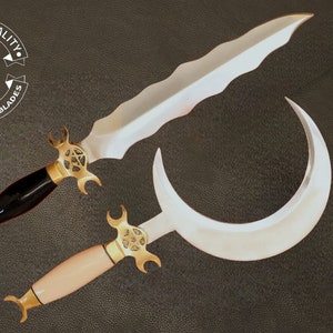 May include: Two decorative swords with ornate gold handles and blades. The sword on the left has a black handle and a straight blade with a serrated edge. The sword on the right has a white handle and a curved blade.