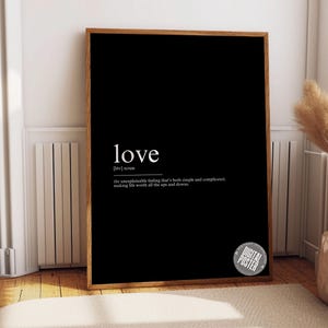 a black picture frame with the words love on it