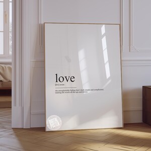 a white picture frame sitting on top of a hard wood floor