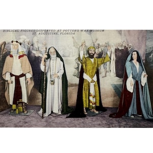 May include: Vintage postcard featuring wax figures of biblical figures displayed at Potter's Wax Museum in St. Augustine, Florida. The figures are dressed in colorful robes and cloaks, with a painted backdrop.