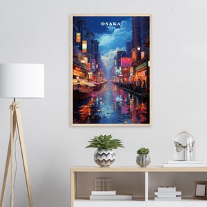 May include: A painting of a nighttime street scene in Osaka, Japan. The street is lined with buildings with colorful lights and signs. The street is wet from rain and reflects the lights. The painting is framed in wood.