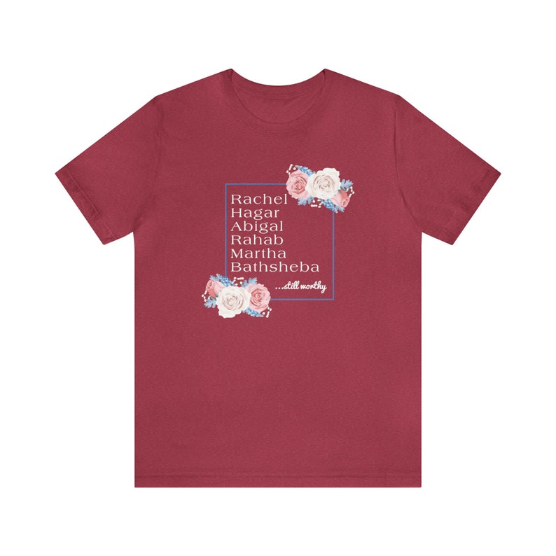May include: A maroon t-shirt with a floral design and the text "Rachel, Hagar, Abigal, Rahab, Martha, Bathsheba...still worthy" inside a blue rectangle.