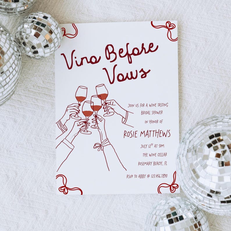 May include: White invitation with burgundy text and illustrations. The text reads "Vino Before Vows" and includes details for a wine tasting bridal shower in honour of Rosie Matthews. Decorative elements include hands toasting with wine glasses.