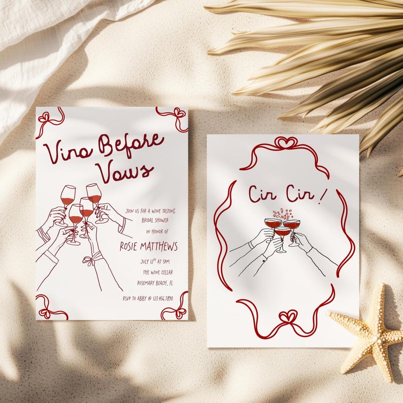May include: Two white cards with red line art. One says "Vino Before Vows" with wine glasses and text. The other says "Cir Cir!" with wine glasses. The cards are on a sandy surface with a starfish and palm fronds.