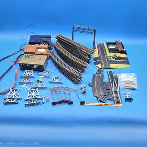 May include: A collection of model train set components, including curved and straight tracks, bridges, a power pack, and various accessories. The set features black tracks, silver bridges, and a brown power pack. The image is set against a blue background.