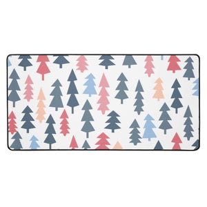 May include: Rectangular white mat featuring a repeating pattern of stylized evergreen trees in shades of blue, pink, and peach. The mat has a black border.