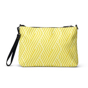 May include: A rectangular clutch bag featuring a yellow and white geometric design. It has a black zip and a black wrist strap. The bag is approximately 30 cm wide and 20 cm tall.