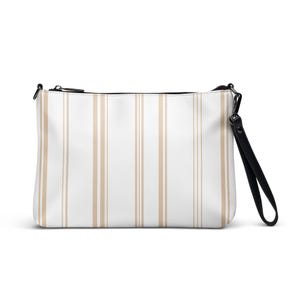 May include: A white clutch bag featuring vertical tan stripes. The rectangular bag has a black zip and a black wrist strap attached to a metal clasp. Designed for carrying essentials.