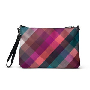 May include: A rectangular clutch bag with a vibrant plaid design in pink, purple, teal, and brown. It features a black wrist strap and a black zip closure. The bag is suitable for carrying small items.
