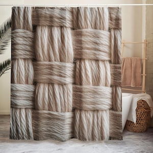May include: A beige and brown woven shower curtain with a textured, basket-weave design. The curtain is made of thick, soft material and hangs from a white rod. The neutral colours and pattern create a cosy, spa-like atmosphere.
