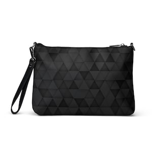 May include: Black clutch bag featuring a geometric triangle design. The bag has a wrist strap and a zip closure. The triangles create a 3D effect. The bag is made of a matte material.