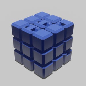 Puede incluir: Un rompecabezas de cubo 3x3x3 azul hecho de cubos más pequeños. El cubo está hecho de un material plástico liso.