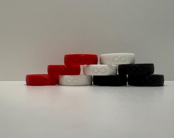 May include: A stack of silicone rings in red, white and black. The rings have an infinity symbol embossed on them.