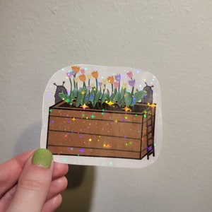 Leuke holografische sticker - Kleine monsters die tulpen eten, bloemen in een houten kist