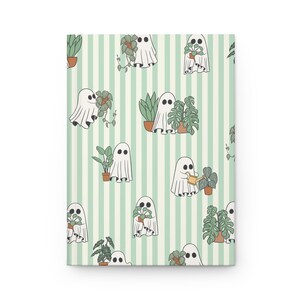 May include: A notebook with a repeating pattern of white ghosts tending to potted plants on a light green and white striped background. The ghosts are watering and holding the plants. The notebook is rectangular.