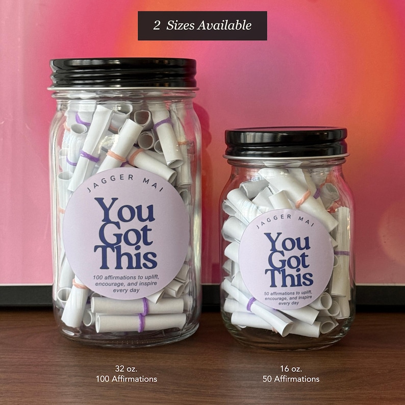 May include: Two glass jars with black lids filled with rolled-up paper scrolls. Each jar has a circular label that reads "You Got This" and "100 affirmations" or "50 affirmations". The jars are 32 oz and 16 oz.