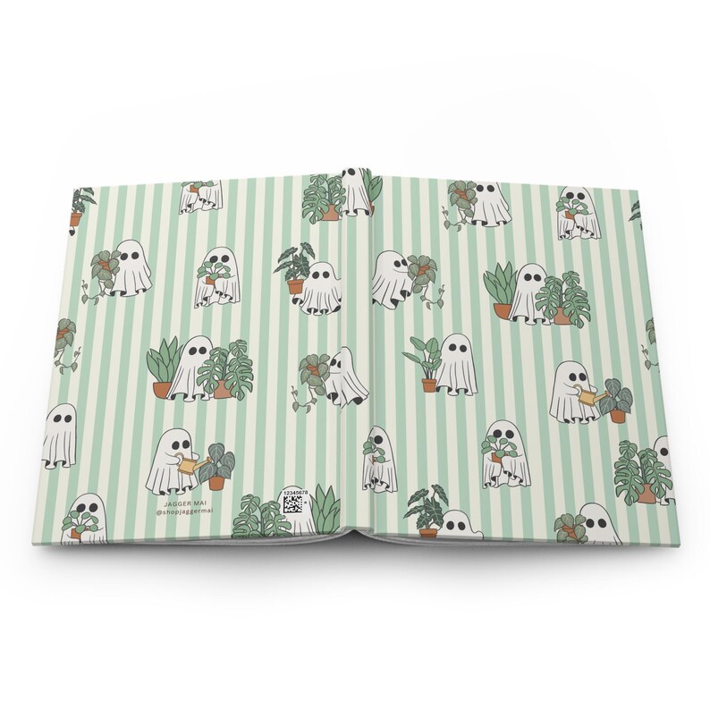 May include: Open journal with a light green striped pattern. The pattern features white ghost illustrations with plants in pots. Some ghosts are watering the plants. The text "Jagger Mai @jaggermai" is visible.