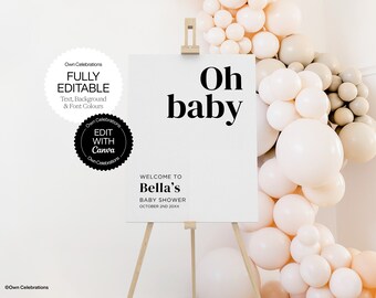 Op de afbeelding: Een wit bord met zwarte tekst die "Oh baby" en "Welkom op Bella's babyshower 2 oktober 20XX" zegt. Het bord staat op een houten ezel voor een muur die is versierd met een ballonboog van beige en witte ballonnen.