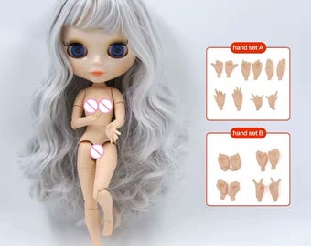 May include: A doll with long wavy silver hair and large blue eyes, featuring articulated limbs and a light skin tone. The doll is accompanied by two separate rectangular charts labeled hand set A and hand set B, each displaying various hand gestures.