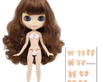 May include: A doll with long, wavy brown hair, large blue eyes, and a pale complexion. The doll has articulated joints at the shoulders, elbows, hips, and knees. Included is a separate rectangular display card featuring sixteen distinct hand poses.