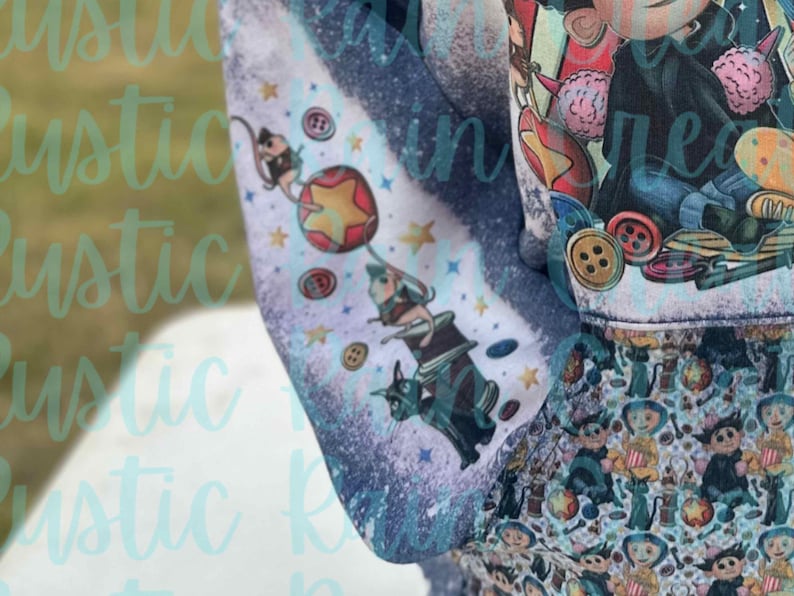 May include: A blue and white fabric with a whimsical design featuring a cat, a mouse, a star, and a balloon. The fabric has a distressed look with a faded background.