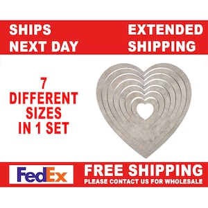 May include: Set of seven wooden heart-shaped stencils in various sizes. The stencils are arranged in a heart shape, with the smallest stencil in the centre. The stencils are a light brown colour.