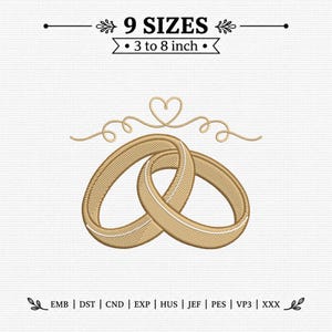 May include: An embroidery design featuring two interlocking gold rings with a thin white line detail, topped with a decorative heart and swirl flourish. Text reads 9 SIZES 3 to 8 inch, with file formats EMB, DST, CND, EXP, HUS, JEF, PES, VP3, XXX.