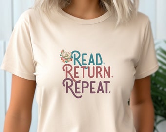 May include: A beige t-shirt with a graphic print that reads "READ RETURN REPEAT" with a stylized image of a stack of books and a flower.