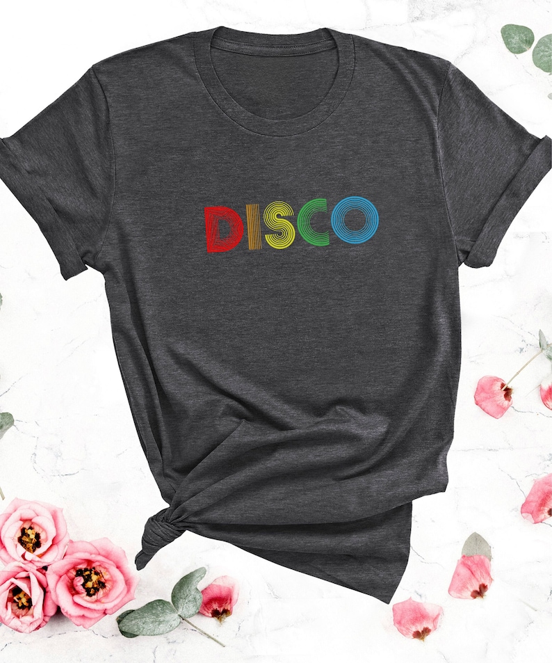 May include: A dark grey t-shirt with the word "DISCO" printed in rainbow colors.
