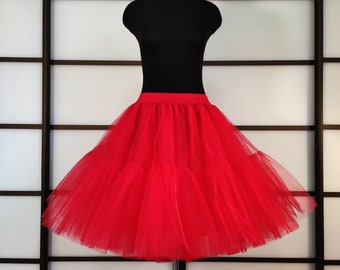 May include: A red tulle petticoat with a gathered skirt and a wide elastic waistband.