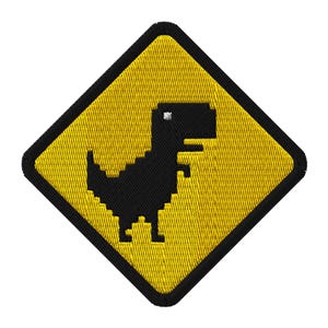 May include: Embroidered patch featuring a black pixelated dinosaur on a yellow diamond-shaped background with a black border. The design is reminiscent of the Google Chrome offline dinosaur game.