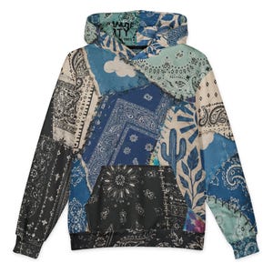 May include: A long-sleeve hooded sweatshirt featuring a patchwork design of various blue, black, and cream bandana patterns. The print includes illustrations of a cactus, clouds, and sun rays. The inner hood label displays the text "MADE BY THE ORIGINAL ONES".