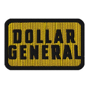 May include: Embroidered patch featuring the words "DOLLAR GENERAL" in bold black letters. The text is set against a textured yellow background, framed by a black border. The patch has a rectangular shape with rounded corners.