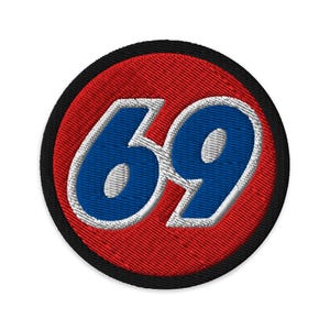 May include: Embroidered patch with the number 69 in blue, outlined in white, on a red background. The patch has a black border and is circular in shape. The design is bold and eye-catching.