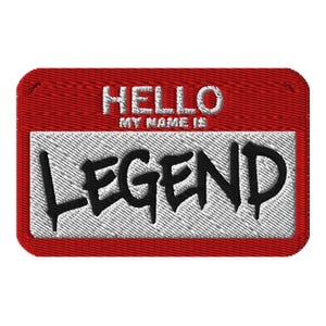 May include: A rectangular embroidered patch with a red border and a white center. The text HELLO MY NAME IS is embroidered in white at the top. The word LEGEND is embroidered in large, bold black letters across the center of the white area.