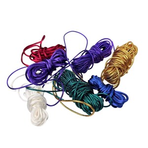 May include: A collection of coiled satin cords in various colors including red, purple, gold, white, blue, and green. Each cord is wound into a small bundle, featuring a smooth, reflective texture and a consistent round profile for crafting projects.