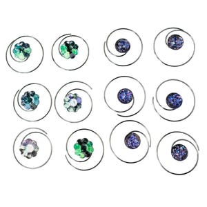 May include: A collection of twelve hair spirals. Each spiral features a silver metal wire design. Some spirals have a cluster of green and blue beads, while others have a dark blue glittery orb.