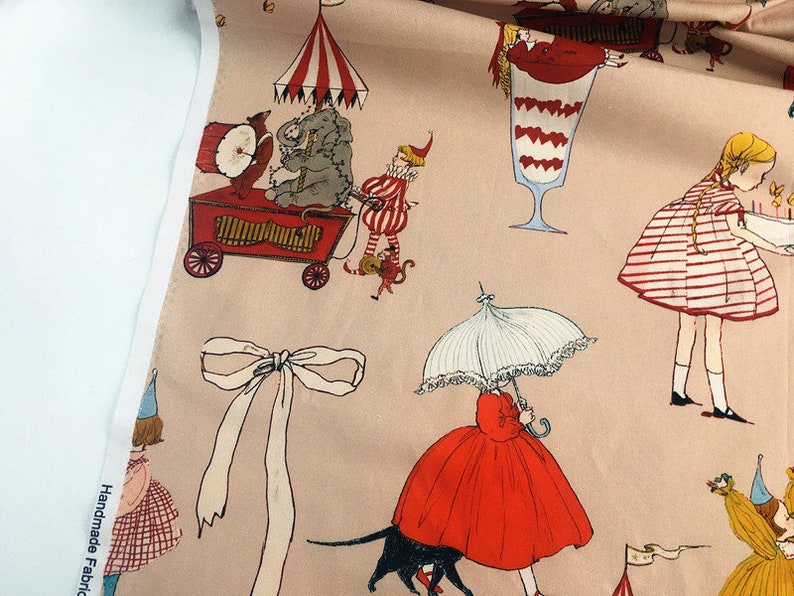 May include: Pink fabric with a repeating pattern of children, circus animals, and desserts. The pattern includes a red and white striped dress, a red and white striped ice cream cone, a red and white striped circus tent, a red and white striped bow, and a red and white striped umbrella.