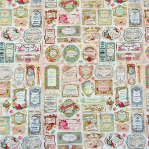 May include: A vintage-style fabric featuring a repeating pattern of ornate labels with floral designs and text in French. The labels are in various shades of pink, blue, green, and gold, and the background is a soft cream colour.
