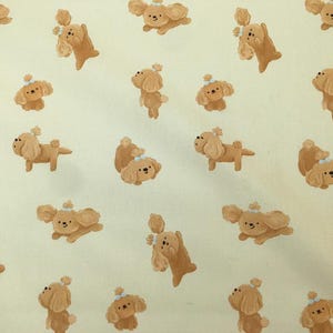 May include: A repeating pattern of cartoon-style brown dogs with white accents and small bows on a light yellow background. The dogs are in various poses, some standing, some sitting, and some jumping.