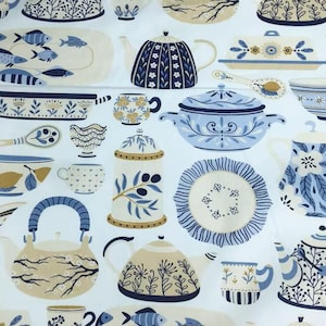 Può includere: Tessuto bianco con un motivo ripetuto di illustrazioni di utensili da cucina blu e beige. Il motivo comprende teiere, tazze, ciotole e piatti da portata con motivi floreali e di pesce. Lo stile ha un'estetica vintage e disegnata a mano.
