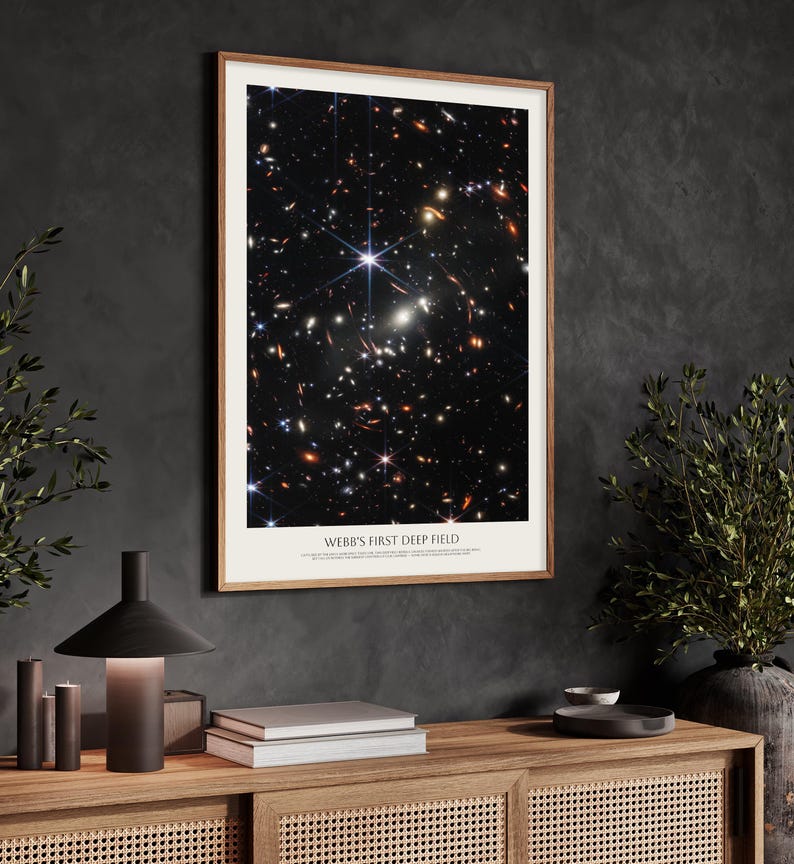 a framed poster of the Webb's First Deep Field, a stunning celestial image of the universe captured by the Hubble Space Telescope.