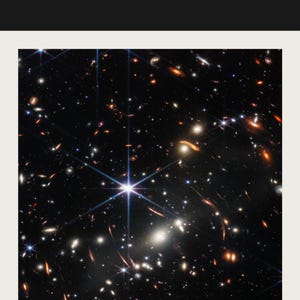 The image is a stunning view of a distant galaxy, showcasing a multitude of stars and celestial objects. The star cluster appears to be composed of numerous bright stars, creating a captivating and visually striking scene. The image is a captivating representation of the vastness and beauty of the universe, with the stars and their intricate patterns and formations filling the frame.