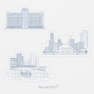 May include: Blue line art illustration of Chicago landmarks, including a large building, a cityscape with a reflective bean-shaped sculpture, and a river scene with a boat. The word "PHILAUTIA" is written in the bottom right corner.