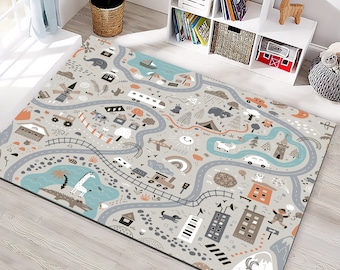 May include: A gray play rug with a road map design featuring cars, trains, and various buildings. The rug has a light gray background with roads in shades of gray and blue. The design includes a sun, rainbow, and cartoon animals.