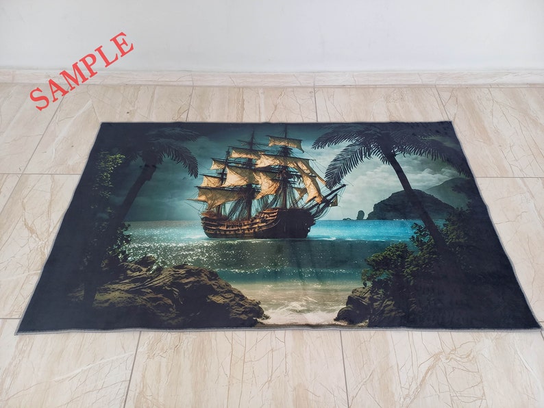 May include: Rectangular rug featuring a detailed illustration of a tall ship sailing on a blue ocean under a cloudy sky. Palm trees frame the scene, with rocky shores in the foreground. The word "SAMPLE" is printed in red.
